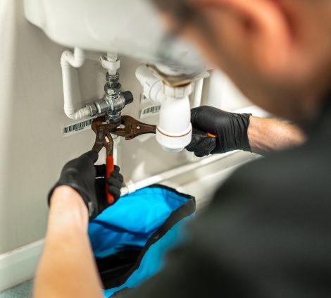 Engineer carrying out remedial plumbing work on a commercial water system