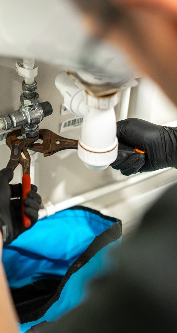 Engineer carrying out remedial plumbing work on a commercial water system