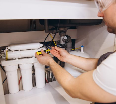 Engineer installing and servicing a commercial water softener system